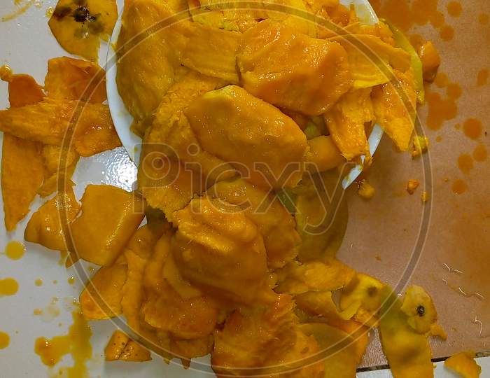 peel of mango and seeds in plate