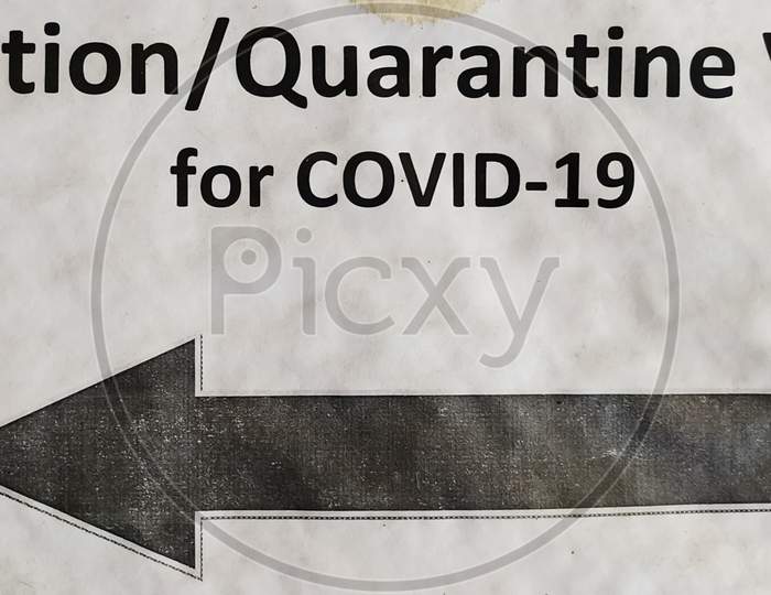 A poster showing direction towards a covid-19 isolation or quarantine ward