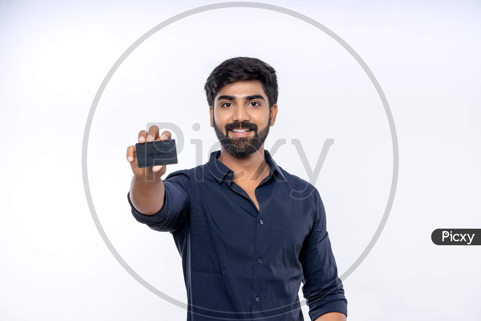 Indian man showing a bank Card for online shopping