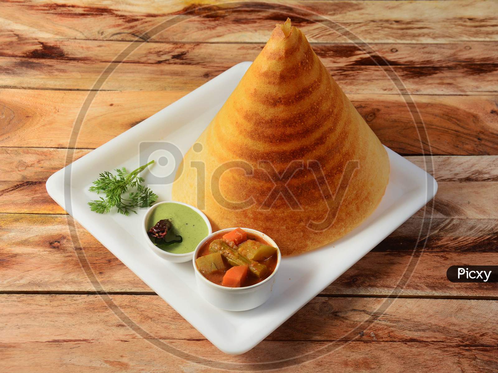 Plain Dosa, A South Indian Traditional And Popular Breakfast Served With Chutney And Sambar Over A Rustic Wooden Background, Selective Focus