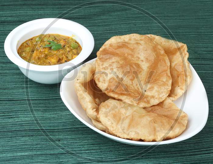 Puri Bhaji - Indian Semi Dry Potato Spicy Recipe Also Known As Batata Or Aloo Ki Sabji, Served With Fried Poori.Selective Focus