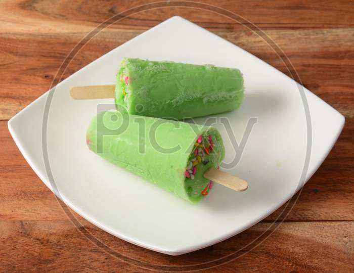 Pan Kulfi Served In White Plate Over A Rustic Wooden Background, Selective Focus