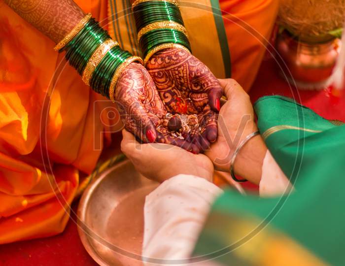 Couple holding hand in marriage in Hindu wedding