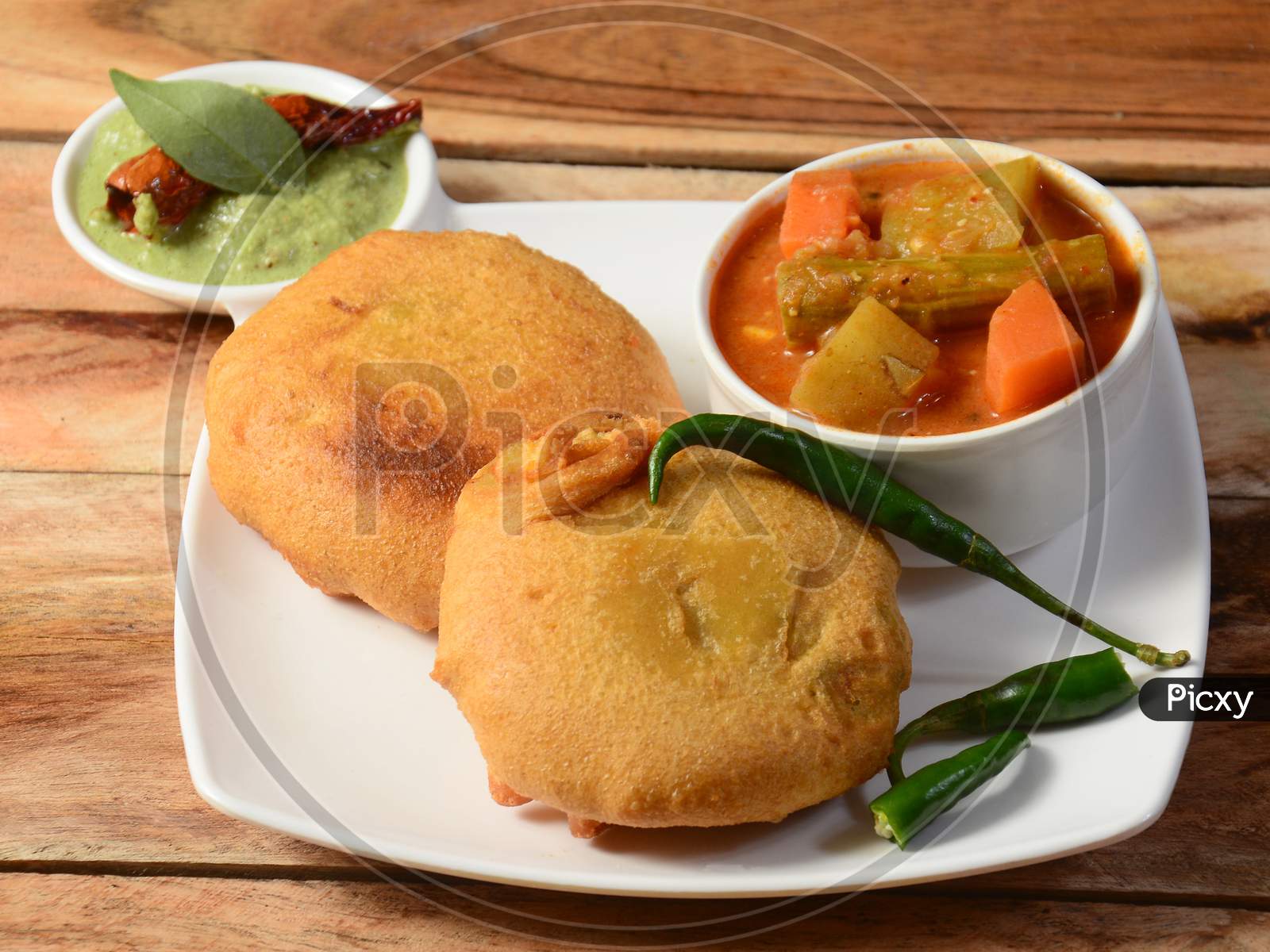 Batata Vada Or Potato Fritter Is A Popular Snack In Maharashtra,India. Mashed Potato Patty Coated With Chick Pea Flour, Which Is Then Deep Fried And Served Hot With Chutney And Sambar, Selective Focus