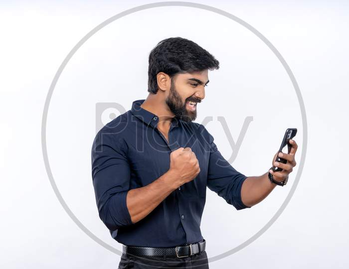 Indian man expressing excitement while using mobile