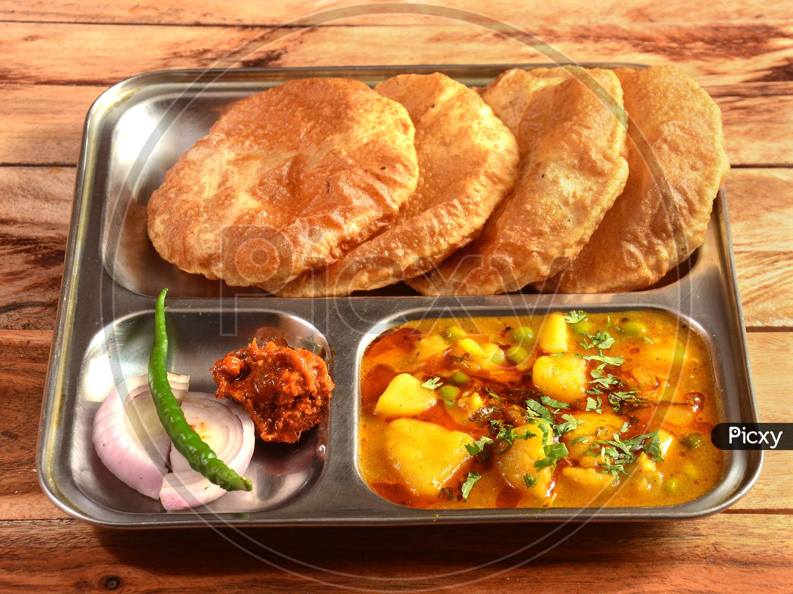 Puri Sabji - Indian Semi Dry Potato Spicy Recipe Also Known As Batata Or Aloo Ki Sabji, Served With Fried Poori.Selective Focus
