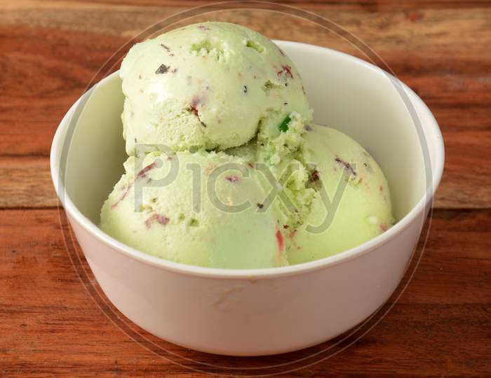 Pan Ice Cream Scoops Served In A Bowl Over A Rustic Wooden Table, Selective Focus