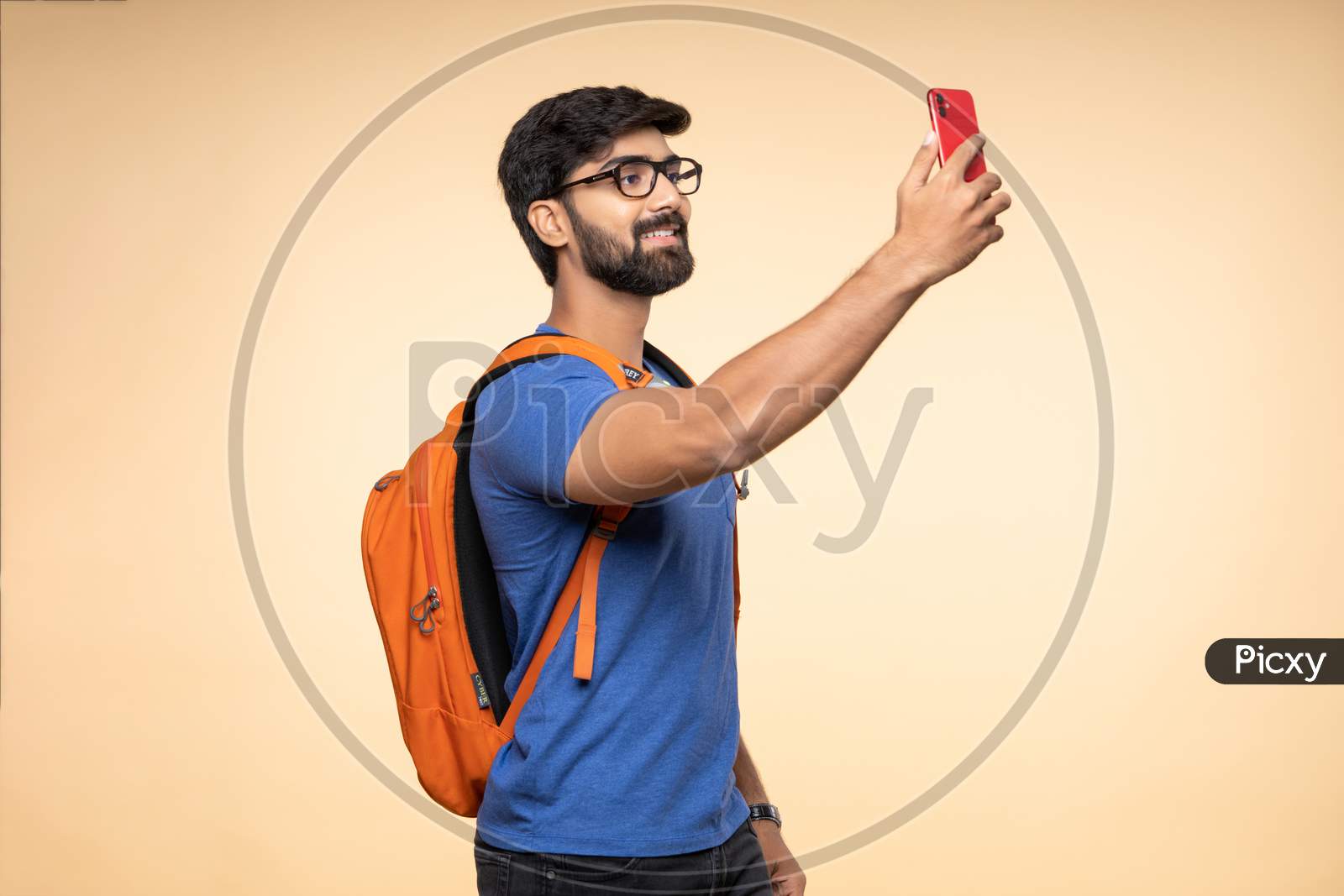 Indian young traveler taking selfie on his smartphone