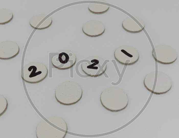 2021 written inside circular white card boards in white background
