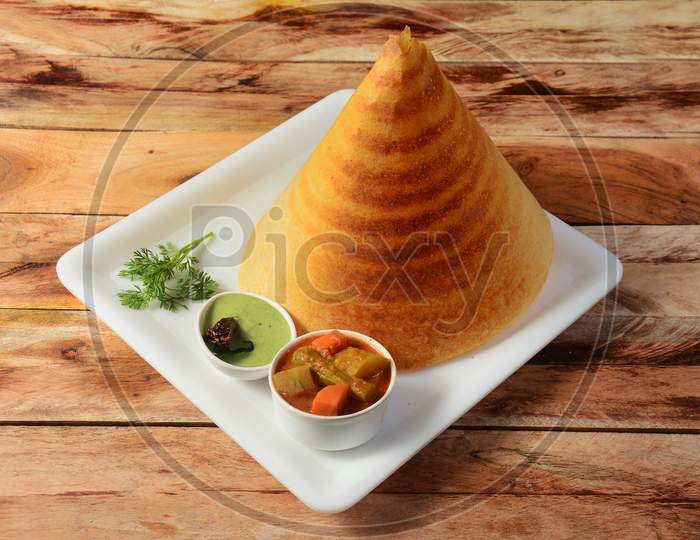Plain Dosa, A South Indian Traditional And Popular Breakfast Served With Chutney And Sambar Over A Rustic Wooden Background, Selective Focus