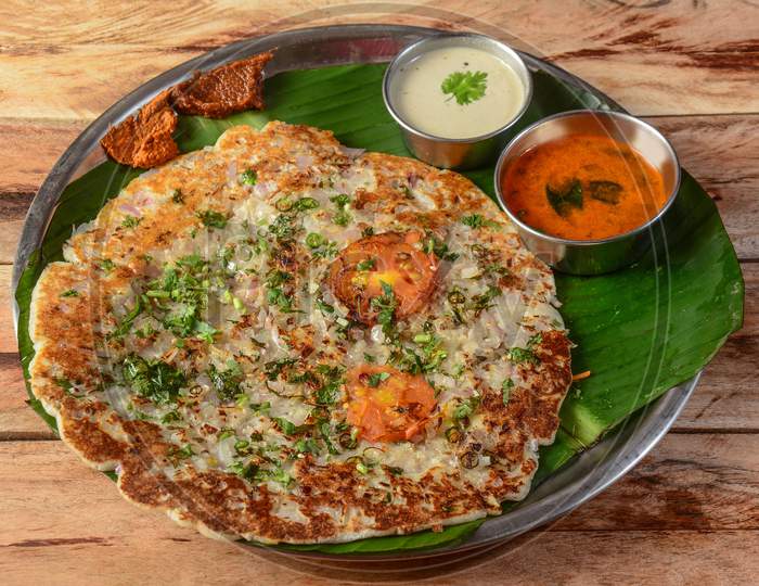 Famous South Indian Food Onion Uttapam Or Ooththappam Is A Dosa Like Dish Made By Dosa Batter, Served With Coconut Chutney And Sambar, Selective Focus