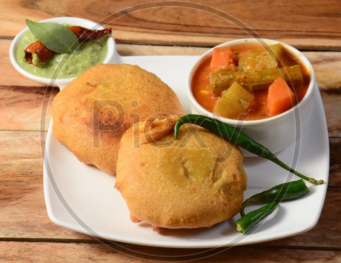 Batata Vada Or Potato Fritter Is A Popular Snack In Maharashtra,India. Mashed Potato Patty Coated With Chick Pea Flour, Which Is Then Deep Fried And Served Hot With Chutney And Sambar, Selective Focus