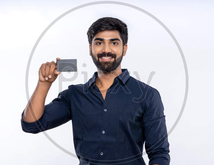 Indian man showing a bank Card for online shopping