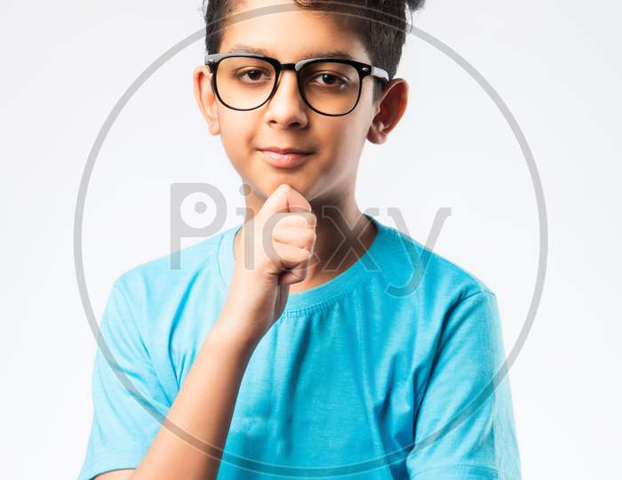 Cute Little Indian Asian Boy In Thinking Pose Against White Background