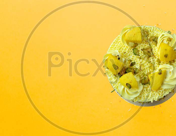 Colorful Birthday Cake With Sprinkles On A Yellow Background With Copyspace
