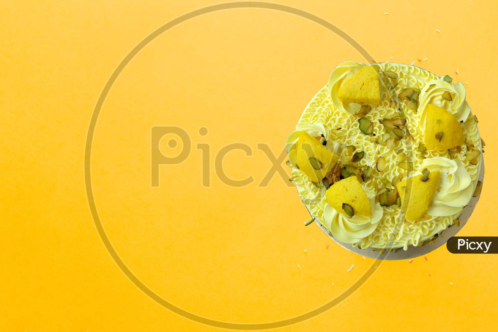Colorful Birthday Cake With Sprinkles On A Yellow Background With Copyspace