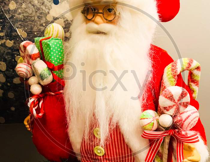 Toy of Santa Claus holding gifts and toys