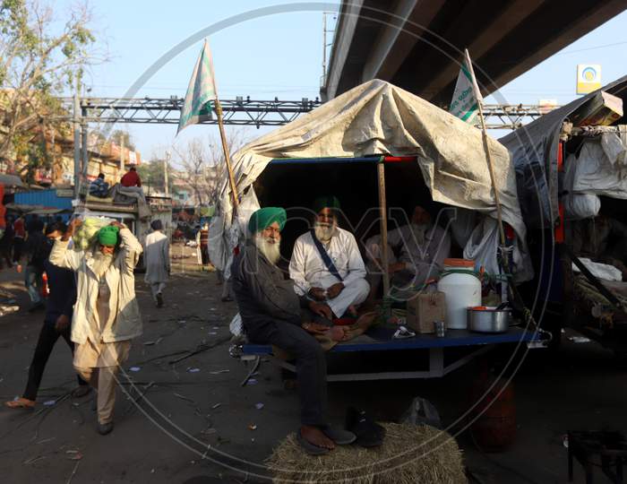Farmers sitting on a blocked highway as they attend a protest against the newly passed farm bills at the Delhi-Haryana border near Tikri. Hundreds of farmers blocked a highway during their nationwide protest against the newly passed farm bills at the Delhi-Uttar Pradesh border in New Delhi.