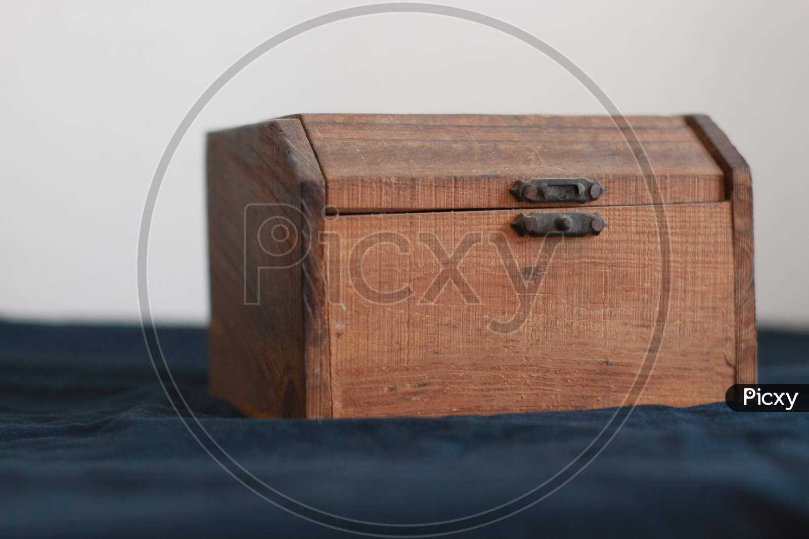 The wooden box on a table.