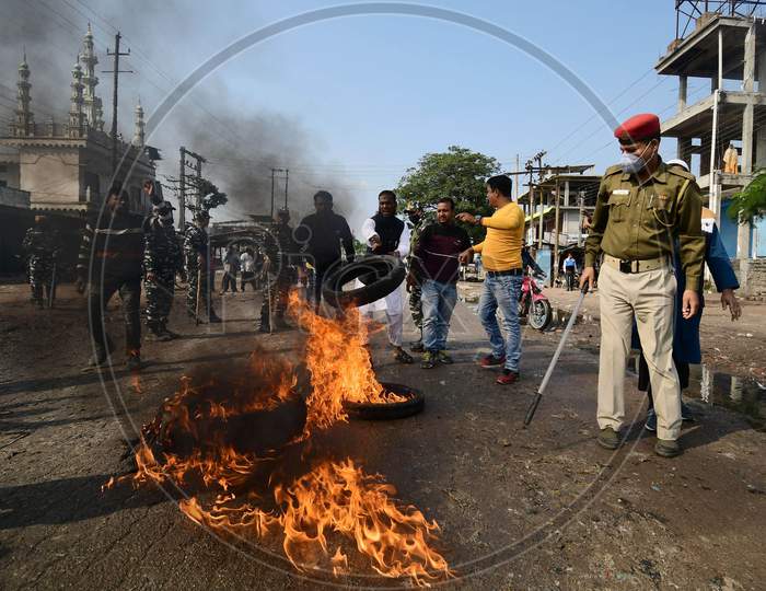 Asom Sankhyalaghu Sangram Parishad activists burn a tyre as they block a road, in support of the nationwide strike called by agitating farmers against Centre's farm reform laws, in Nagaon District of Assam on Dec 8,2020.