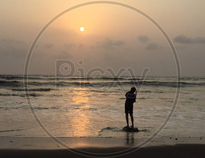 Sunset on beach with children playing
