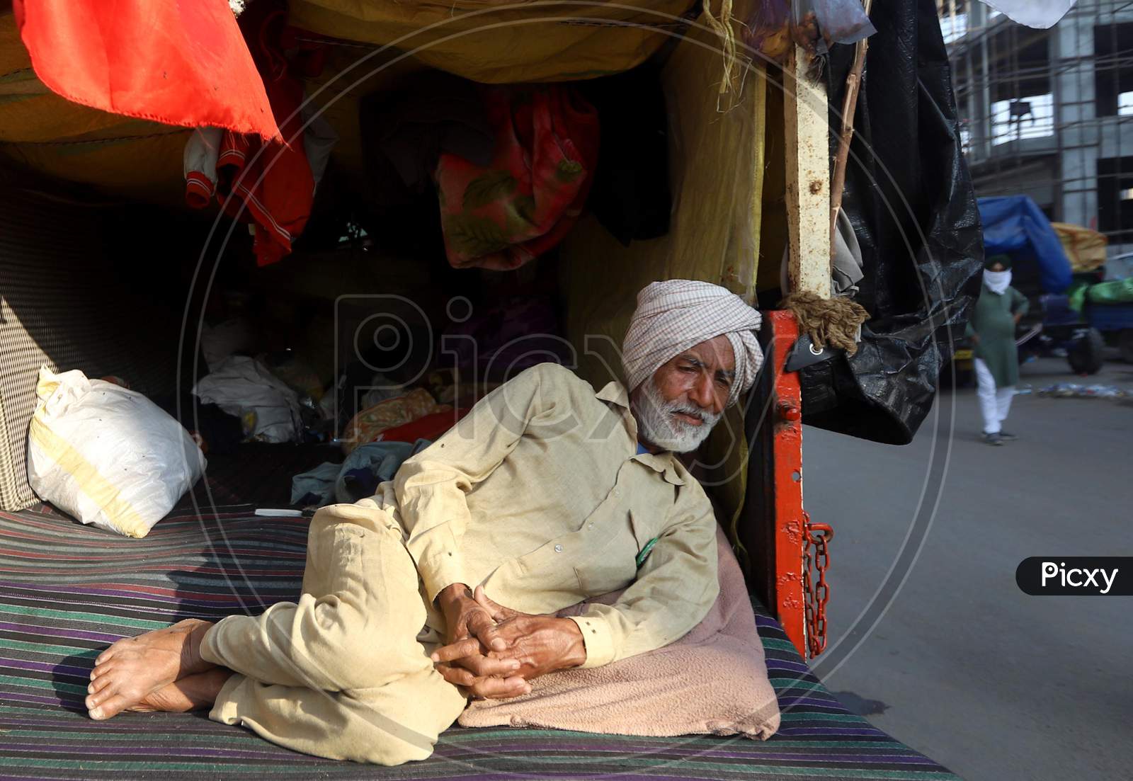 Image of Farmers sitting on a blocked highway as they attend a protest ...