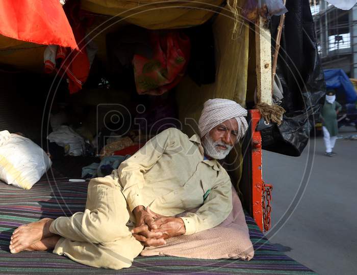 Farmers sitting on a blocked highway as they attend a protest against the newly passed farm bills at the Delhi-Haryana border near Tikri. Hundreds of farmers blocked a highway during their nationwide protest against the newly passed farm bills at the Delhi-Uttar Pradesh border in New Delhi on Decemb