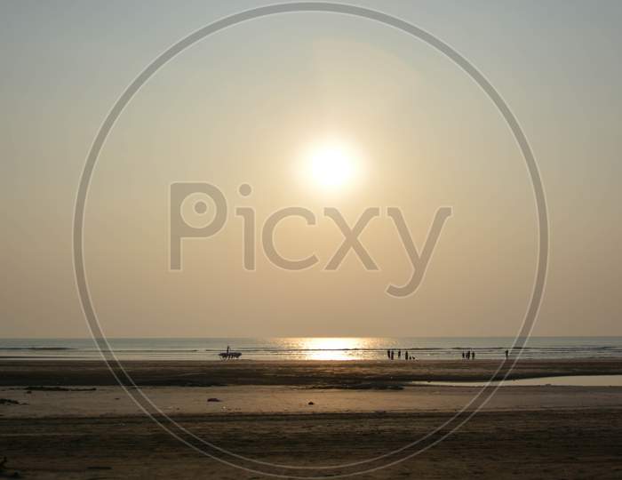 People enjoying the sunset on the beach at Murud Beach, Dapoli, Maharashta