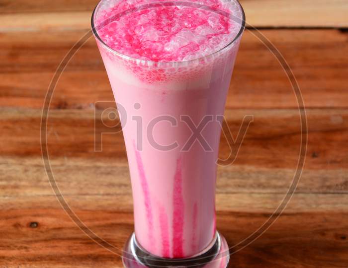 Strawberry Milkshake Served In A Glass Over A Rustic Wooden Background,A Refreshing Drink For Summer Days, Selective Focus On Top