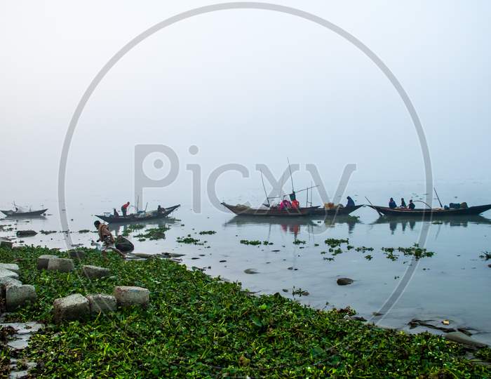 Fisherman Taking Preparation For Fishing In The Foggy Winter Morning