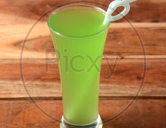 Green Apple Soda Served In A Glass Over A Rustic Wooden Background,A Refreshing Drink For Summer Days, Selective Focus On Top
