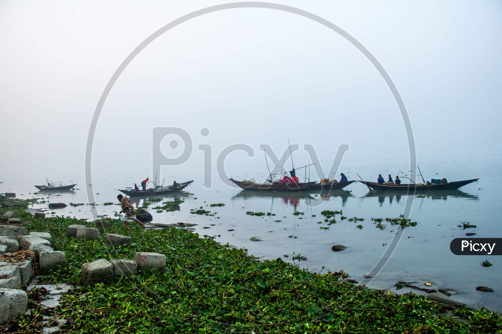 Fisherman Taking Preparation For Fishing In The Foggy Winter Morning