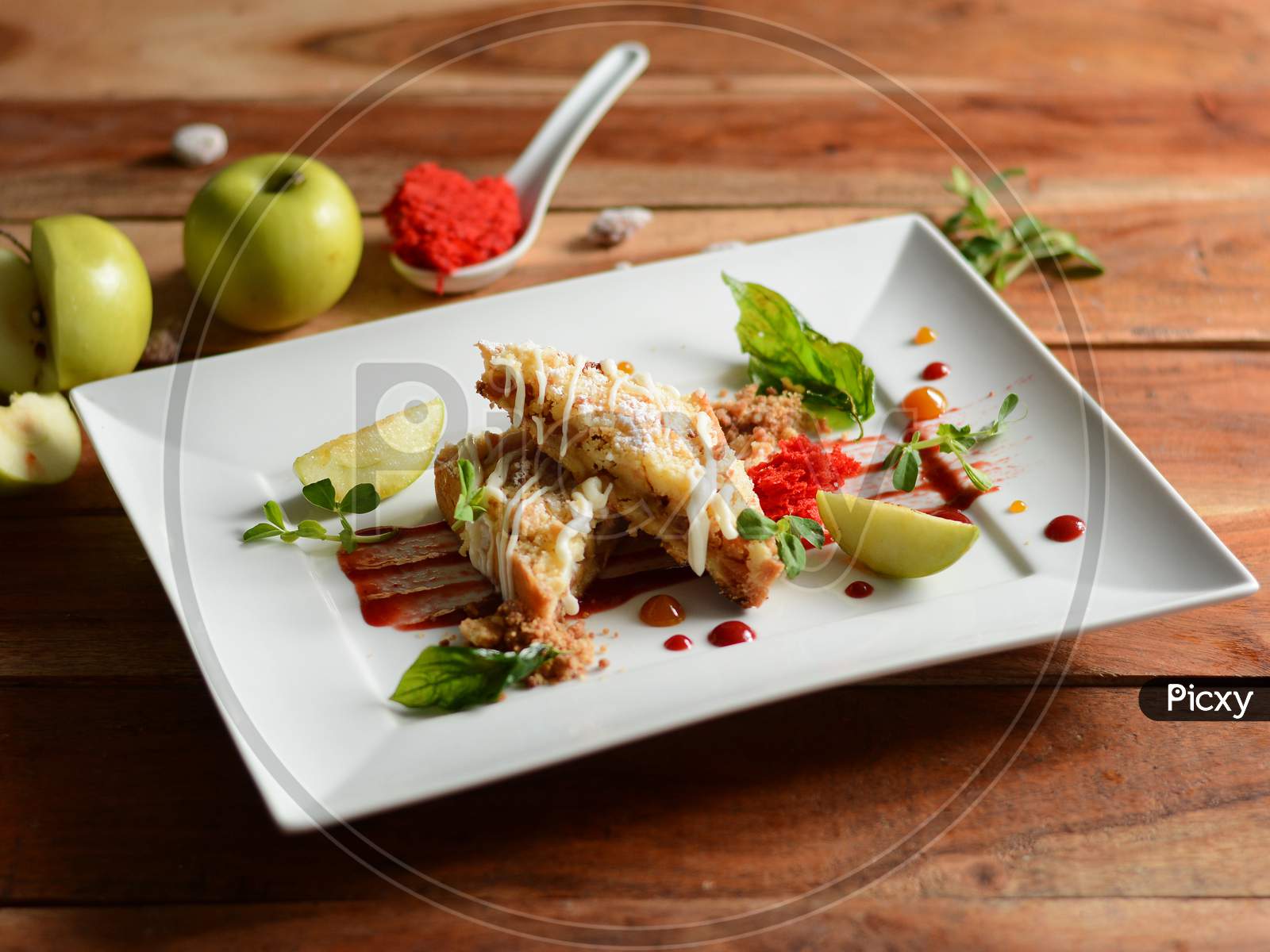 Apple Pie With Basil Served In A White Plate On A Rustic Wooden Table, Selective Focus