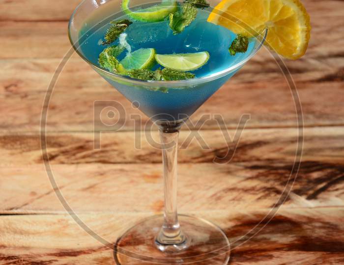 Blue Curacao Cocktail Decorated With Lemon Slice And Mint Leaves. Selective Focus On Top