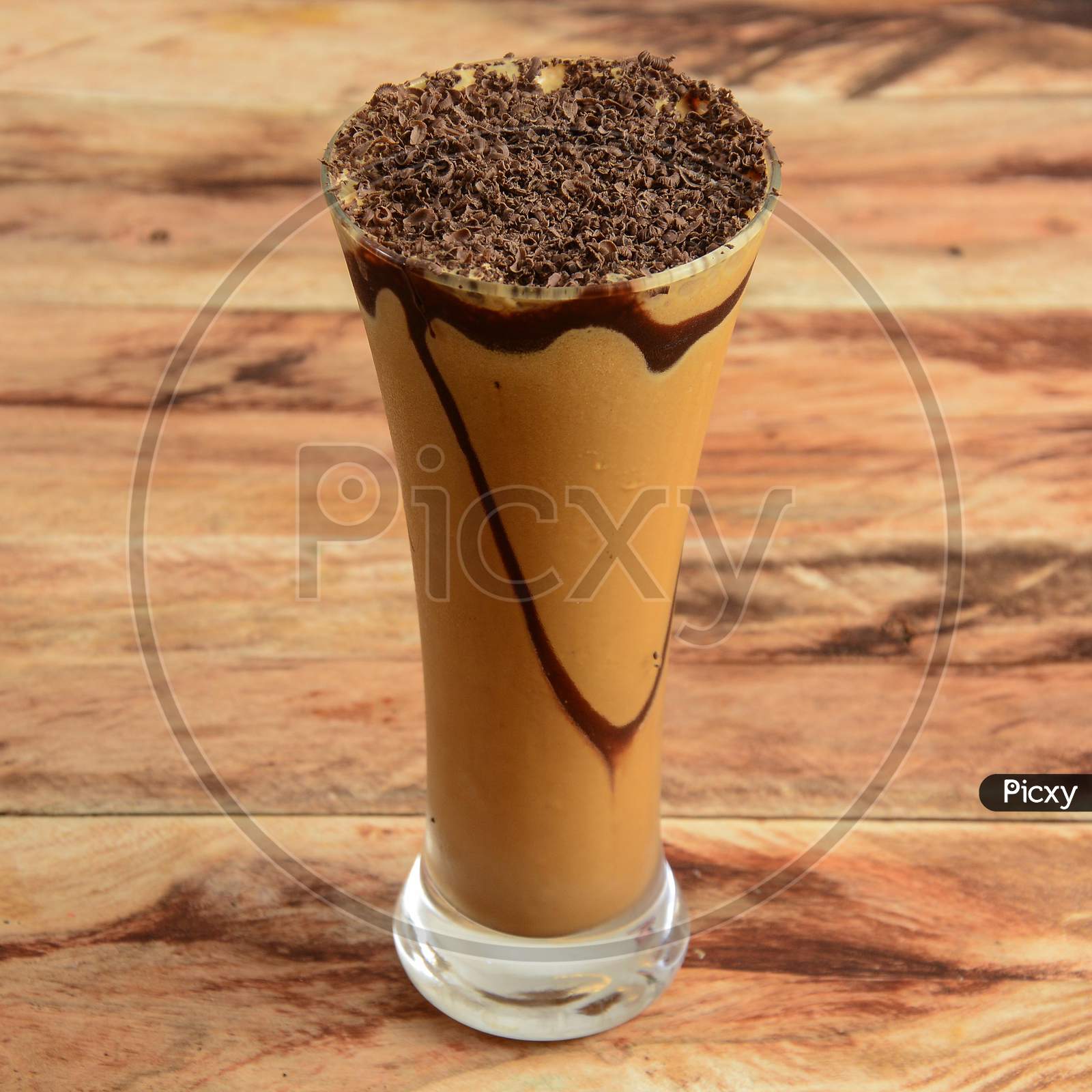 Chocolate Cold Coffee Served In A Glass Over A Rustic Wooden Background,A Refreshing Drink For Summer Days, Selective Focus On Top
