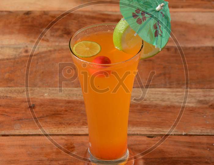Orange Mojito Served In A Glass Over A Rustic Wooden Background,A Refreshing Drink For Summer Days, Selective Focus On Top