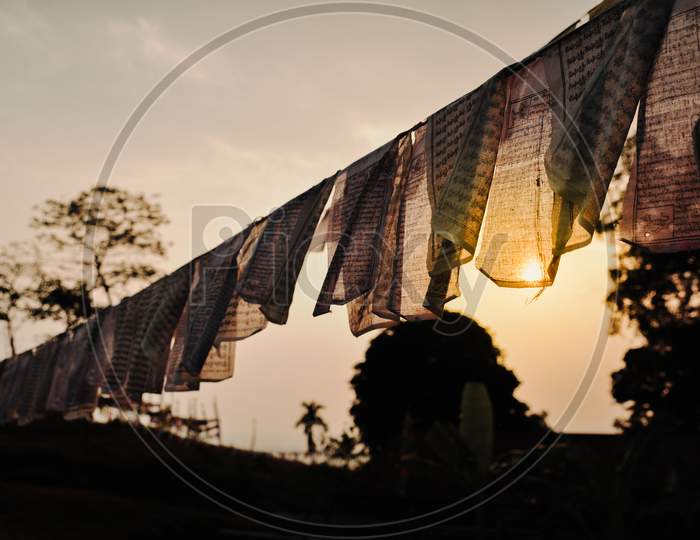 Bhutan -  sun shining through the peace flag