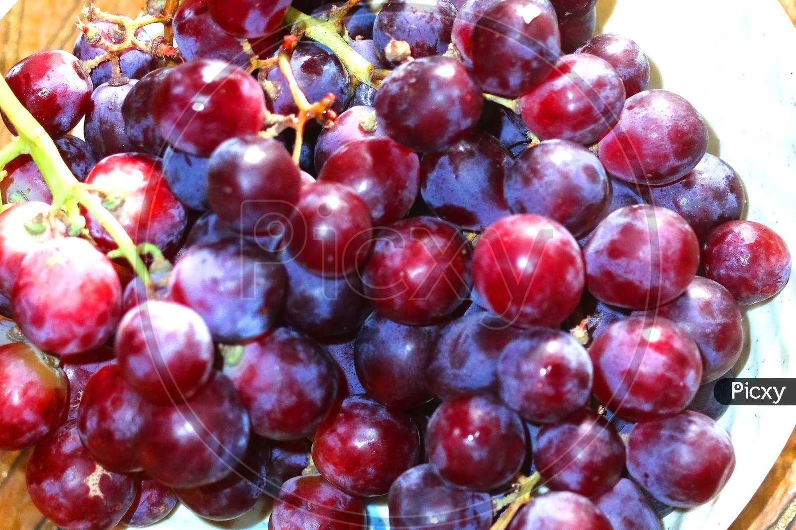 Healthy fruits Red wine grapes background dark grapes blue grapeswine grapes,Red wine grapes backgrounddark grapes,blue grapes,Red Grape in a supermarket local market bunch of grapes ready to eat