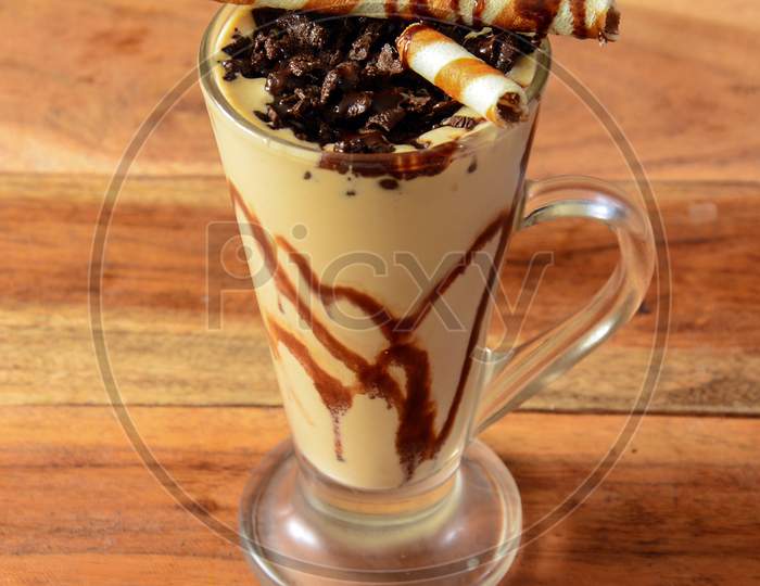 Chocolate Milkshake Served In A Glass Over A Rustic Wooden Background,A Refreshing Drink For Summer Days, Selective Focus On Top
