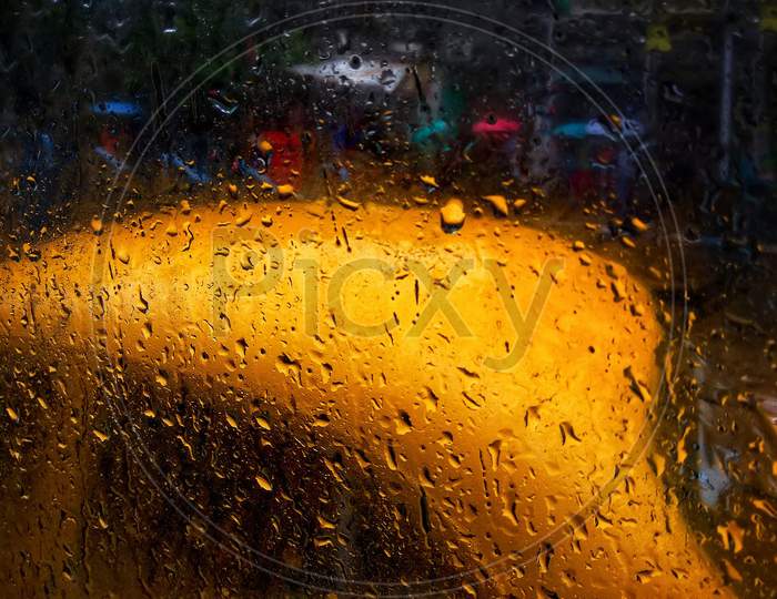 Raindrops Falling On Glass, Abstract Blurs - Monsoon Stock Image Of Traditional Yellow Taxi Of Kolkata Formerly Calcutta City , West Bengal, India