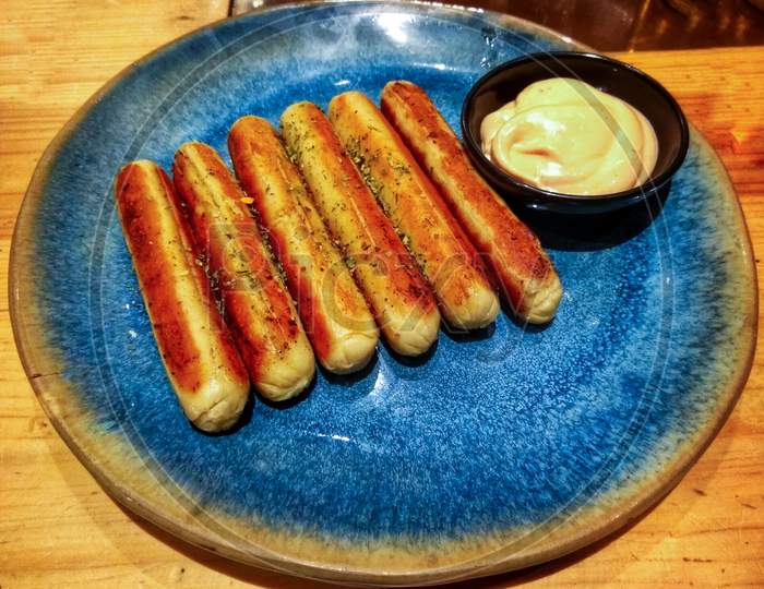 Sausage Roasted Into A Blue Plate