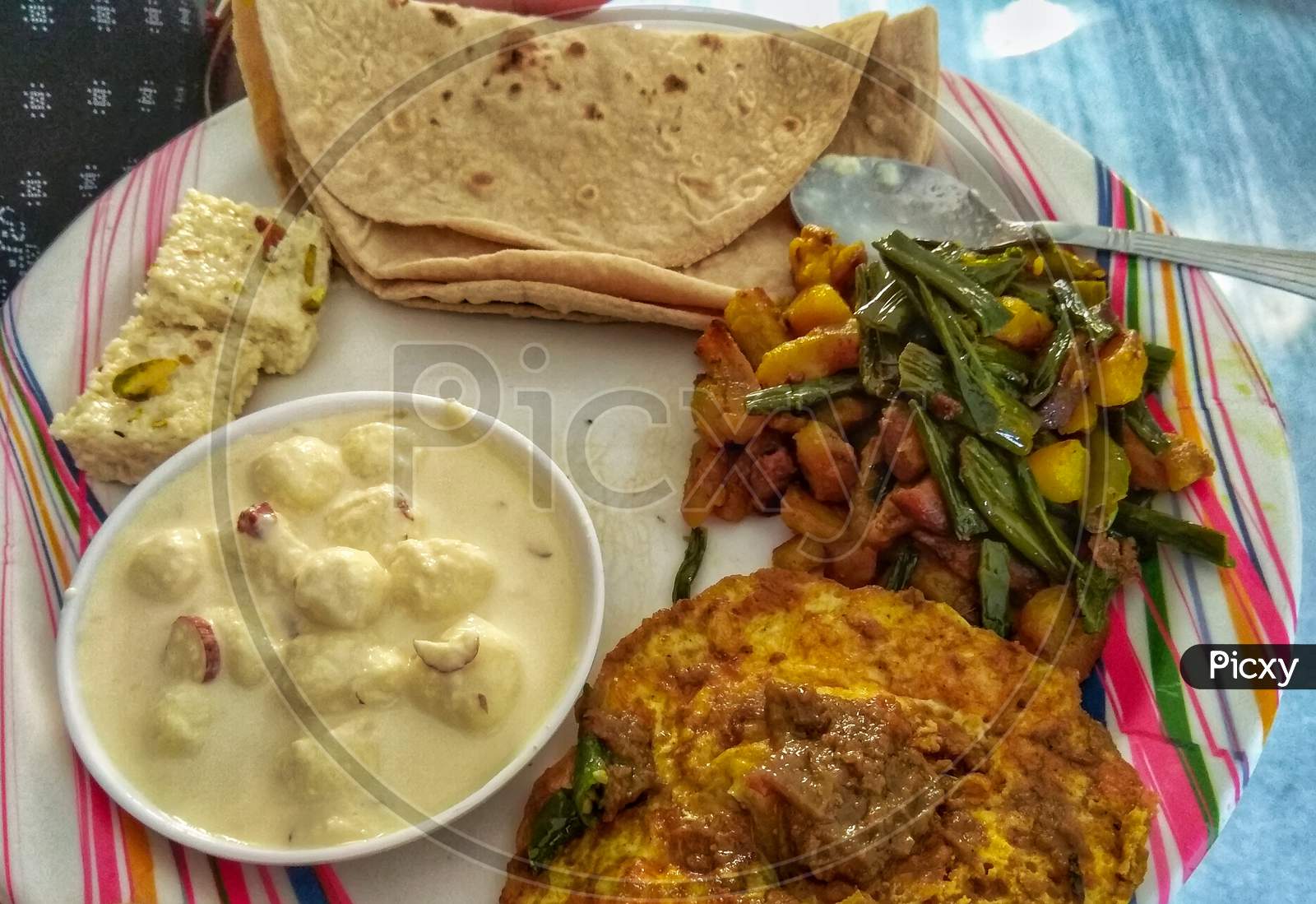 Roti, Omlet, Mix Veg And Rasmalai In A White Plate