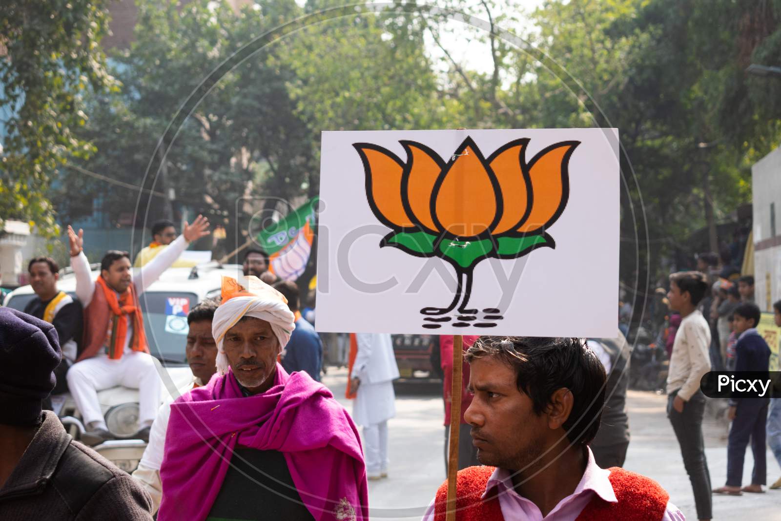 Men having electoral sign for BJP during Bharatiya Janata Party campaign for Delhi Assembly Election 2020