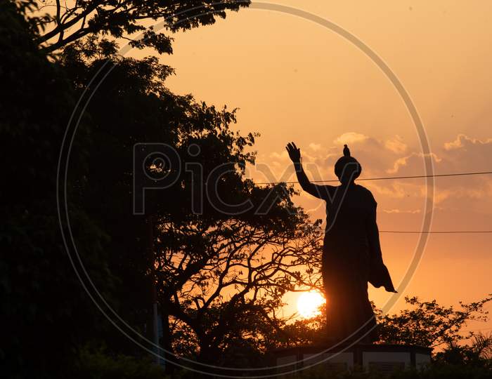 Silhouette of Indira Gandhi Statue during sunset