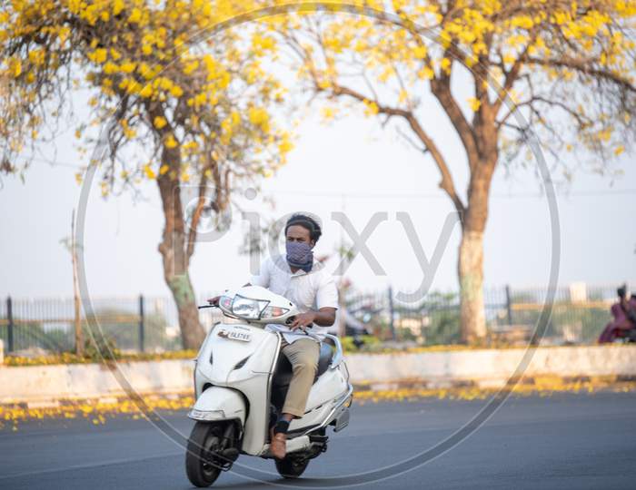 Indian Man wearing face mask riding bike