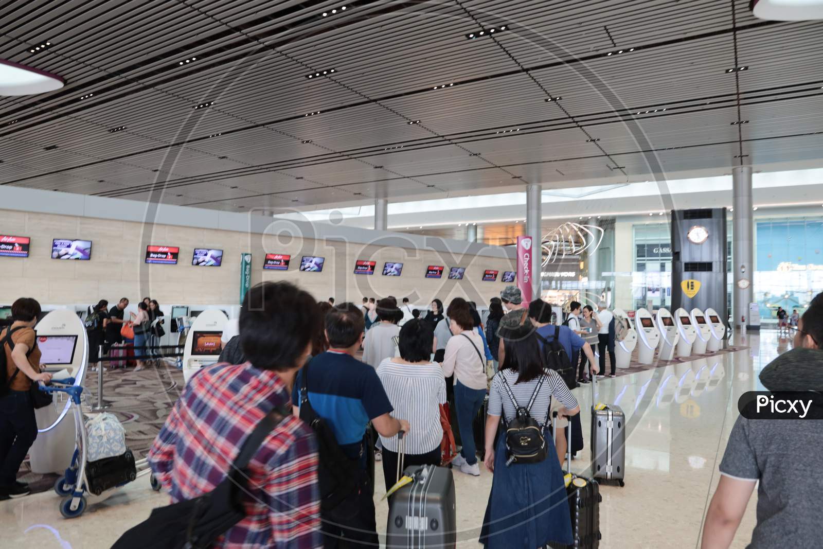 Passengers In Queue Lines At Airport  Web Checkin Kisok