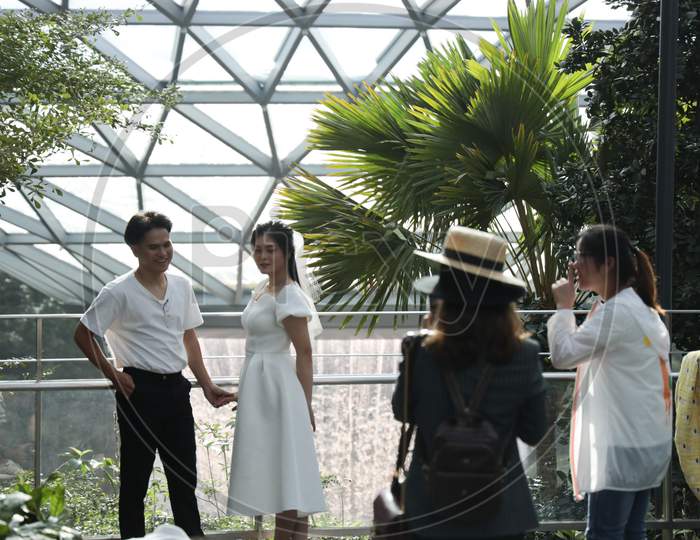 Couple Posing For Photos At The Jewel Changi Airport , Singapore