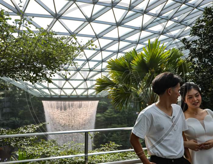 Couple Near Jewel, Vortex Waterfalls At Changi Airport , Singapore