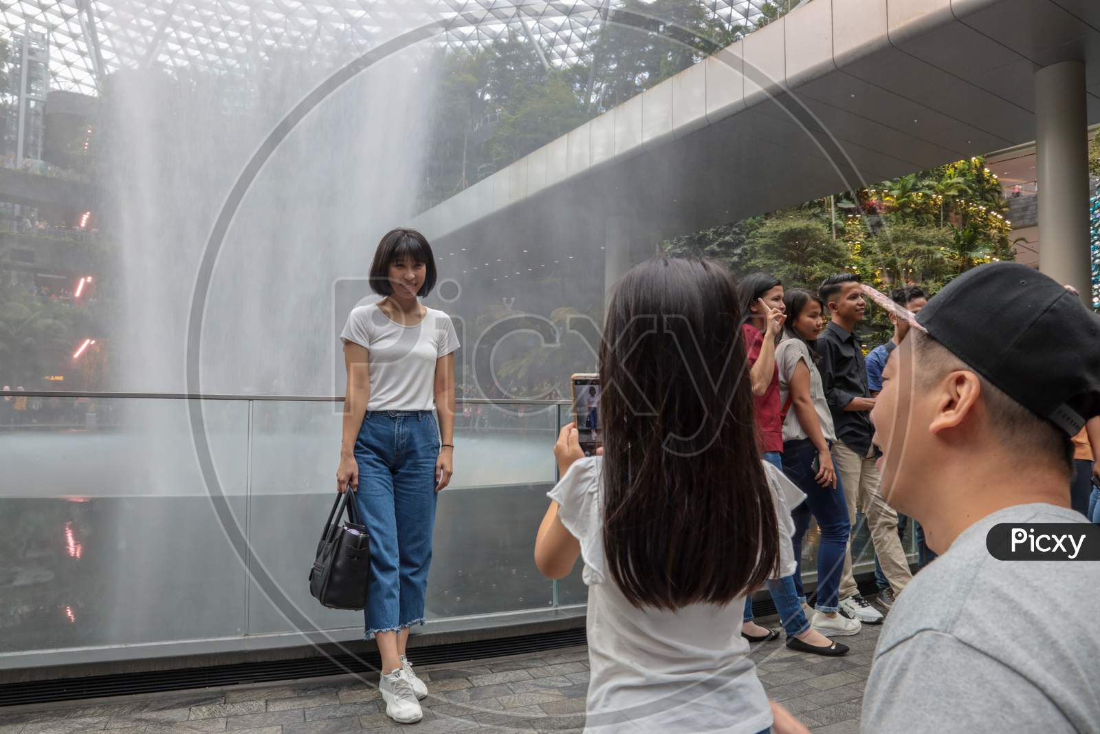 Tourists At Vortex Water Fall At Jewel Changi Airport, Singapore