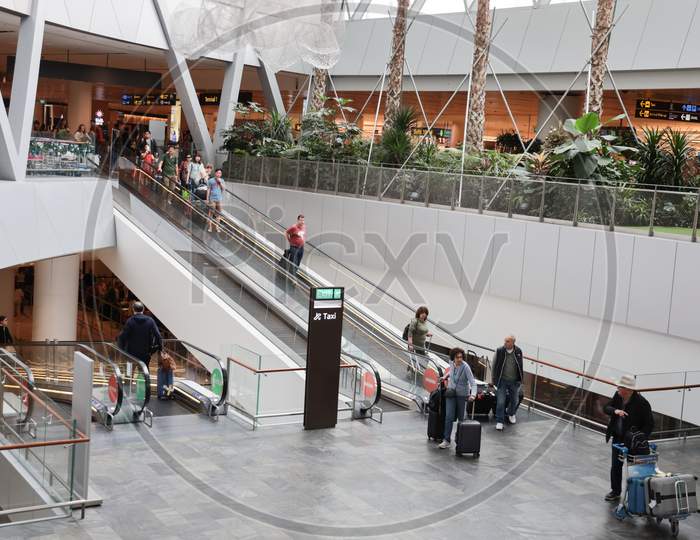Airport Travel Scenes With Passengers  Carrying Luggage Bags At Changi Airport, Singapore